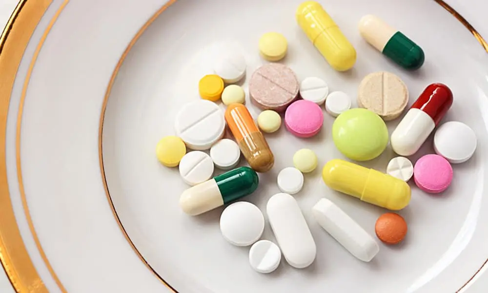 Various pills on a decorative plate.