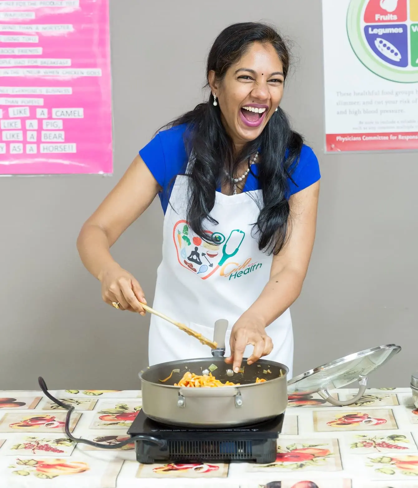 Woman joyfully cooking with a spatula.