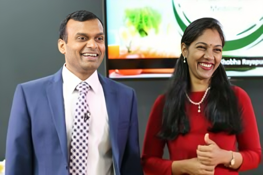 Smiling man and woman in formal attire.