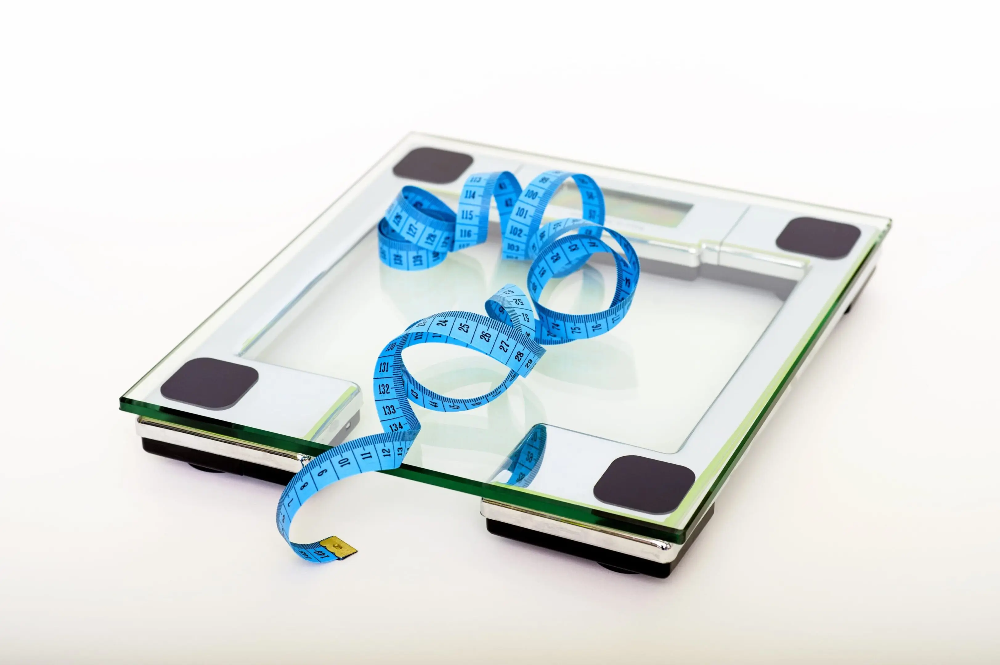Digital scale with blue measuring tape.