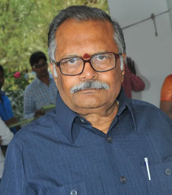 Man in blue shirt with glasses.