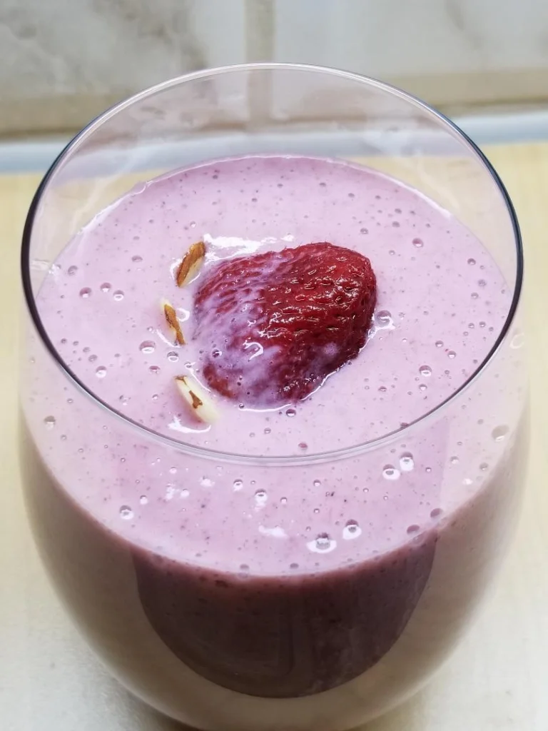 Strawberry smoothie with almond slices.