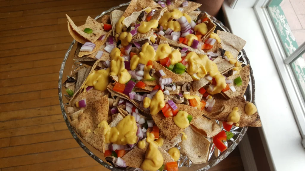 Nachos with cheese, onions, and peppers.