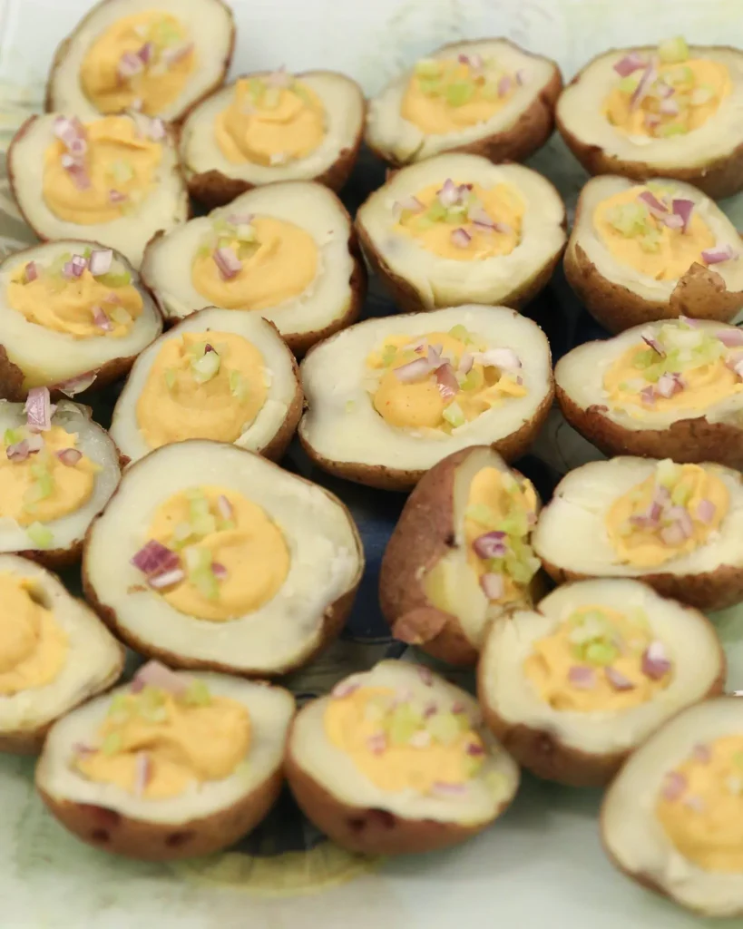 Deviled eggs topped with chopped onions.