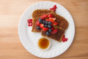 French toast with berries and syrup.