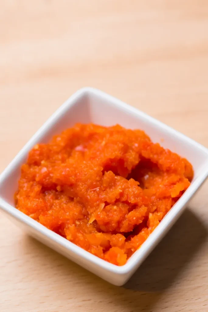 Orange paste in a small white dish.