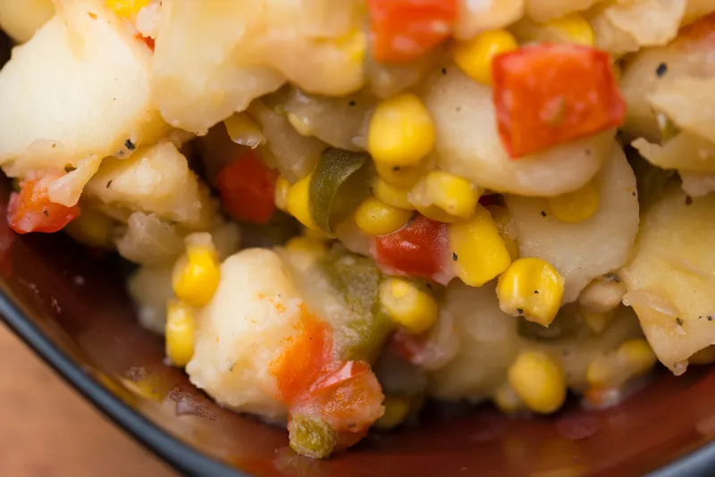 Mixed vegetables with potatoes in a bowl.