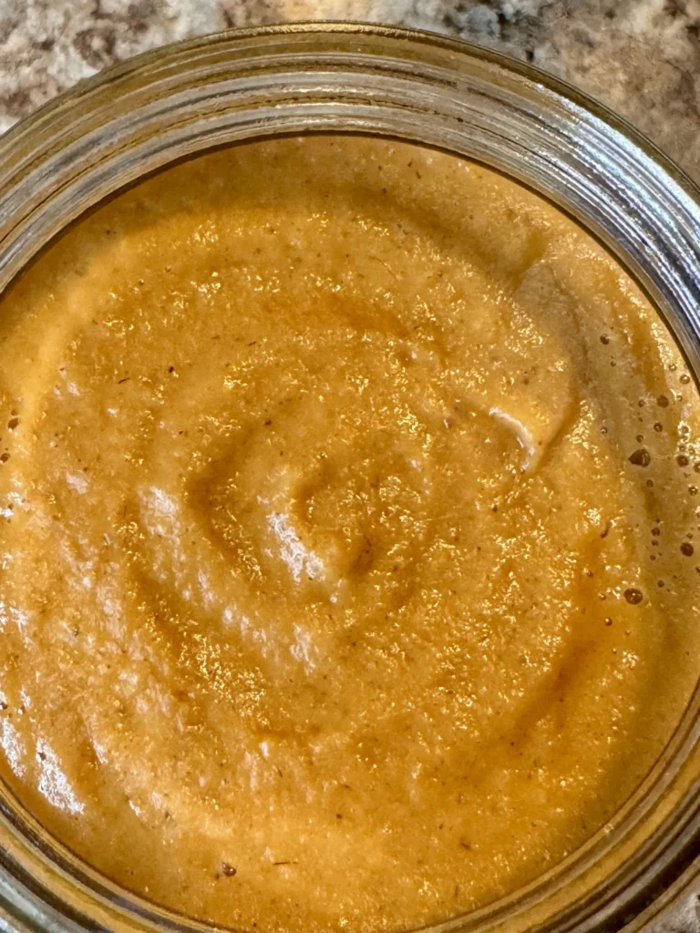 Jar of smooth, creamy peanut butter.