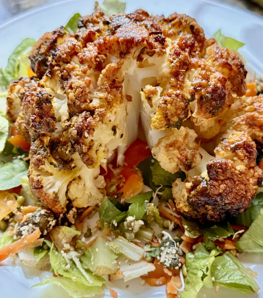 Roasted cauliflower served on mixed salad.