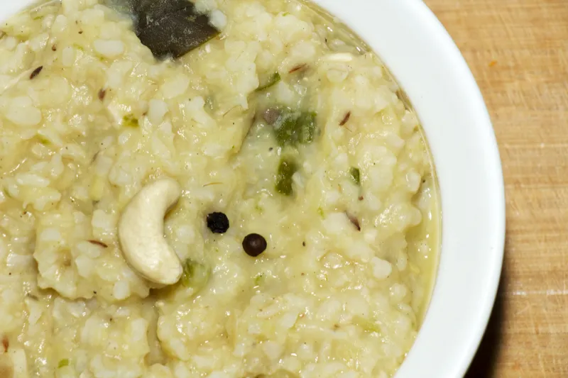 Creamy rice dish with cashew garnish.