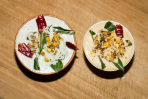 Two bowls of Indian chutney on table.