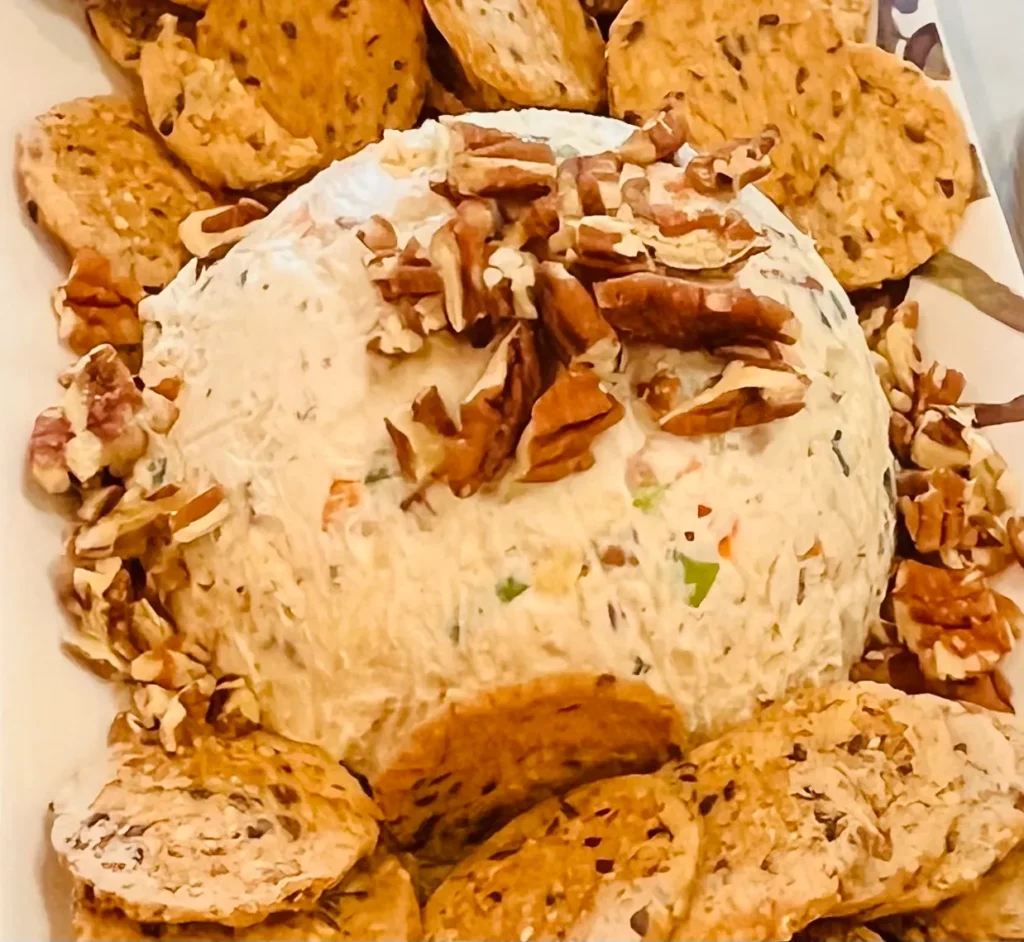 Cheese ball with crackers and pecans.