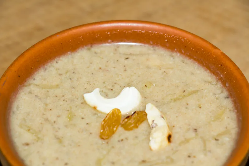 Creamy kheer garnished with nuts and raisins.
