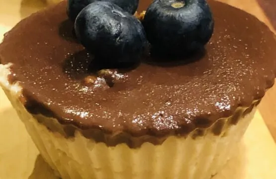 Chocolate cupcake topped with blueberries.