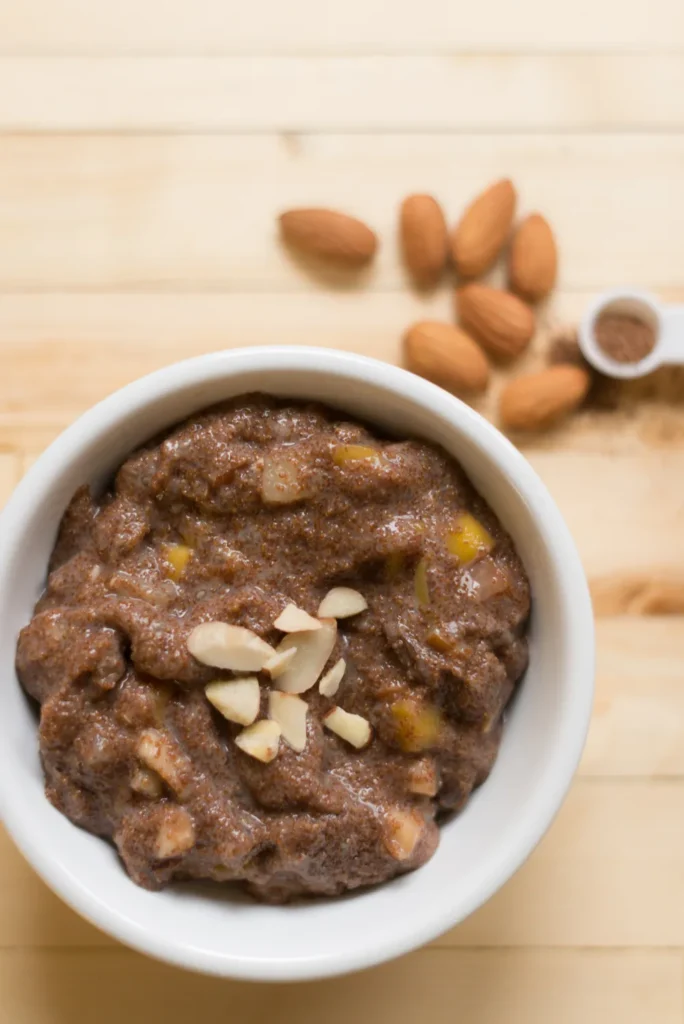 Bowl of chocolate pudding with almonds.