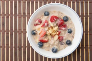 Bowl of oatmeal with berries and almonds.