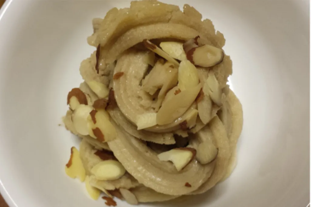 Swirled dessert topped with sliced almonds.