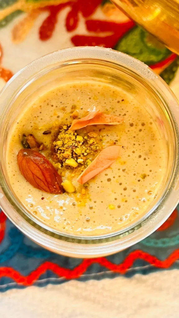 Creamy dessert topped with nuts and petals.