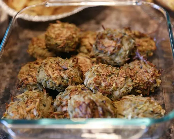 Baked vegetable fritters in a glass dish.