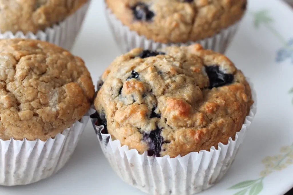 Blueberry muffins on a white plate.