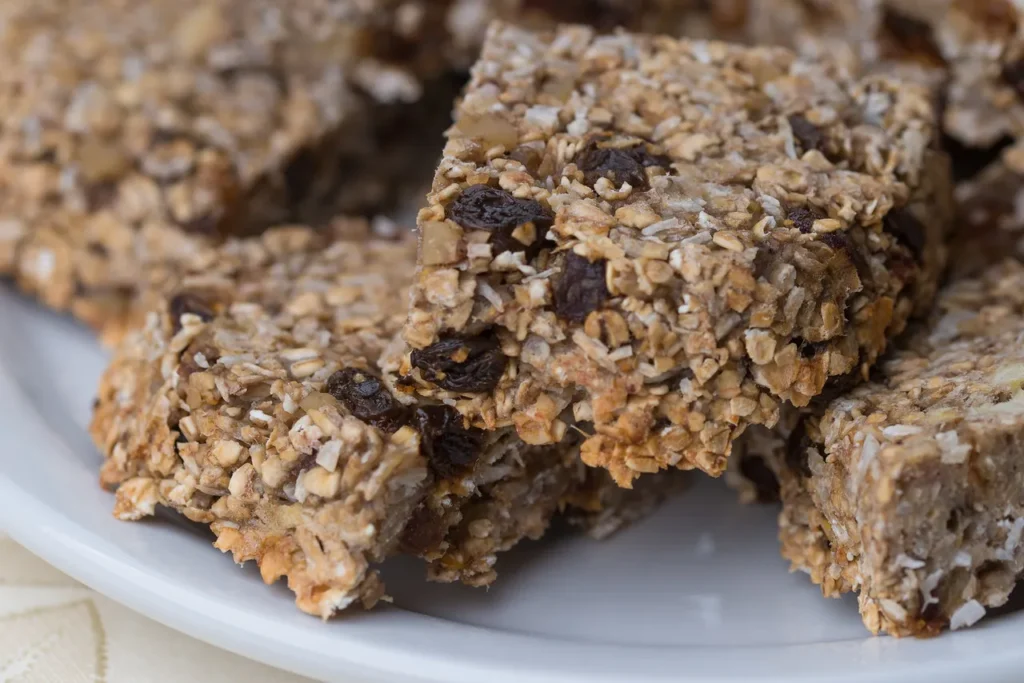Granola bars with raisins on a plate.