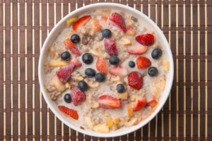 Bowl of oatmeal with mixed fruits.