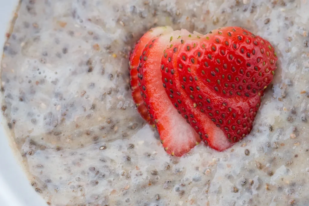 Chia pudding topped with sliced strawberries.
