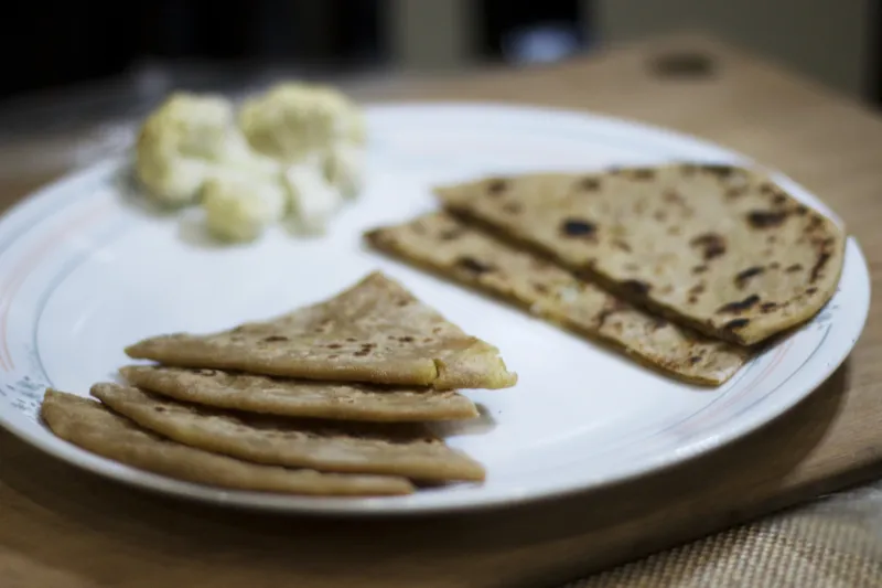 Plate with parathas and cauliflower florets.