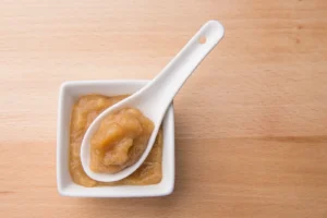 Apple sauce in a bowl with spoon.