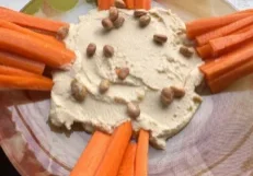 Carrot sticks with hummus and nuts.
